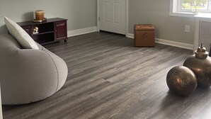 A spacious room with a ceiling fan, a large mirror, a door, and a window with a view of trees. - COZY SUITE DREAM HOME IN BLOOMFIELD  (Bloomfield)