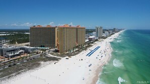 A coastal hotel with multiple high-rise buildings, a sandy beach, and a clear blue ocean. - Calypso 3-1809 Gulf View King Master, Free Golf&Perks, Pier Park, Heated Pool (Panama City Beach)