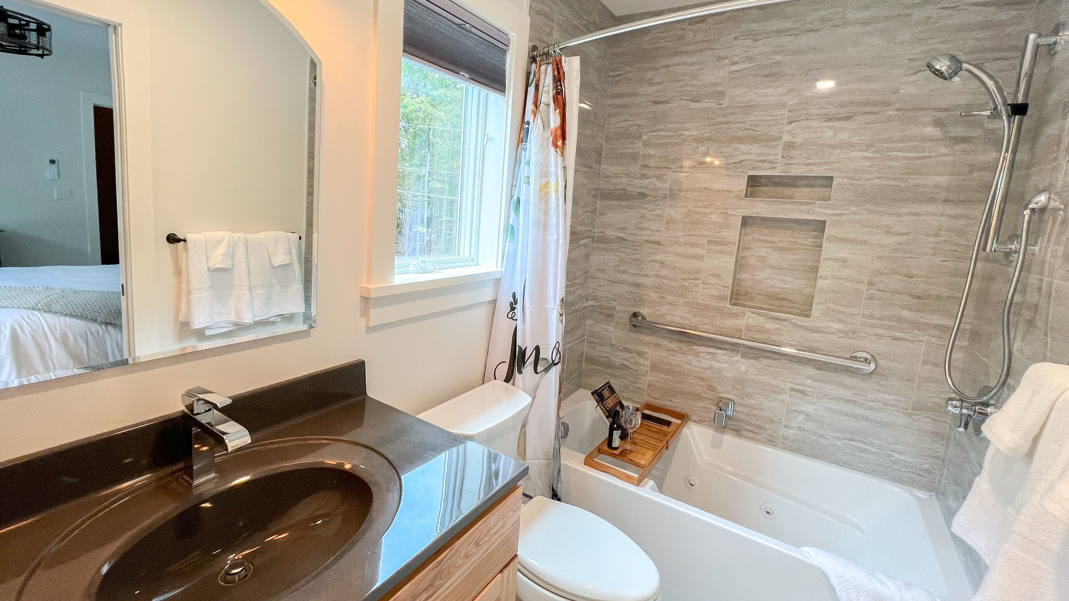 A modern bathroom with a large sink, toilet, and bathtub.