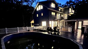 A two-story house with a swimming pool, a covered patio, and a white fence. - Four Seasons For Fun (Lakeville)