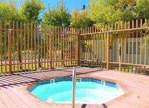 A small, rectangular swimming pool with a wooden deck surrounding it. - Large, renovated Interlaken condo that accommodates 10! (June Lake)