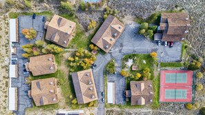 An aerial view of a residential area with multiple houses, a tennis court, and a parking lot. - Large, renovated Interlaken condo that accommodates 10! (June Lake)