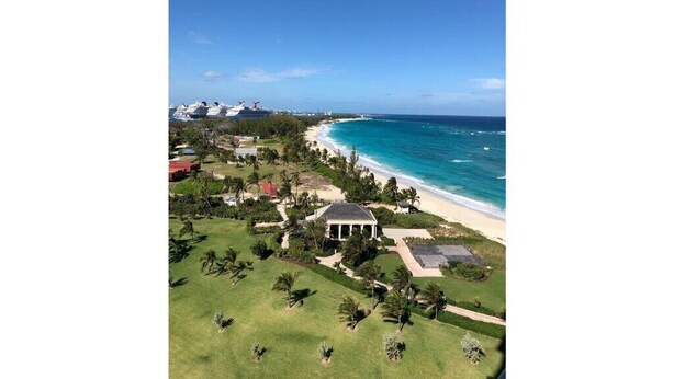An aerial view of a coastal property with a beach, a large house, and several boats in the background. - Gorgeous Studio The Reef Atlantis

 (Nassau)