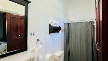 A bathroom with a sink, toilet, and shower curtain.