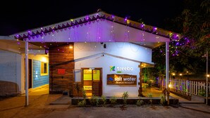 A beach resort with a reception area, wooden exterior, and string lights. - Treebo Salt Water Beach Resort (Dapoli)