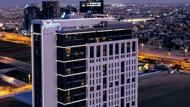 A high-rise hotel with a modern design, featuring a prominent sign at the top. - Radisson Hotel & Residence Riyadh Olaya (Riyadh)