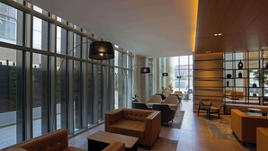 A modern interior with large windows, leather sofas, and a minimalist design. - Radisson Hotel & Residence Riyadh Olaya (Riyadh)