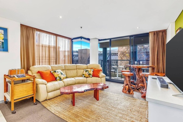 The living room is cosy with warm and light streaming in from glass windows softened by sheer mocha coloured curtains. Enjoy the sunshine on the soft lounge with a good book, tv show or simply enjoy the view.