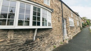 A stone building with large windows and a narrow street. - York House (Pickering)