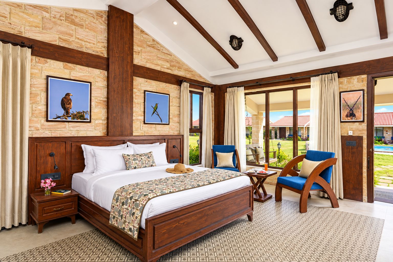 A spacious bedroom with a large bed, a wooden headboard, a nightstand, and a chair.