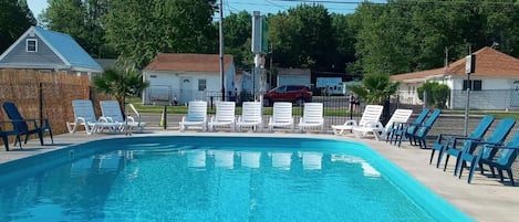 Seasonal outdoor pool, open 8:00 AM to 8:00 PM, pool loungers