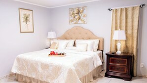 A neatly arranged bedroom with a large bed, two bedside tables, and a nightstand. - Cozy Country Retreat Ranch Style Home, private hot tub, pet friendly (Sanford)