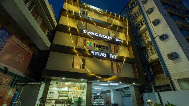 A hotel with a sign for Swagatam Inn and a Treebo logo. - Swagatam Inn (Guwahati)