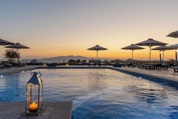 Seasonal outdoor pool, open 9:00 AM to 6:30 PM, pool umbrellas