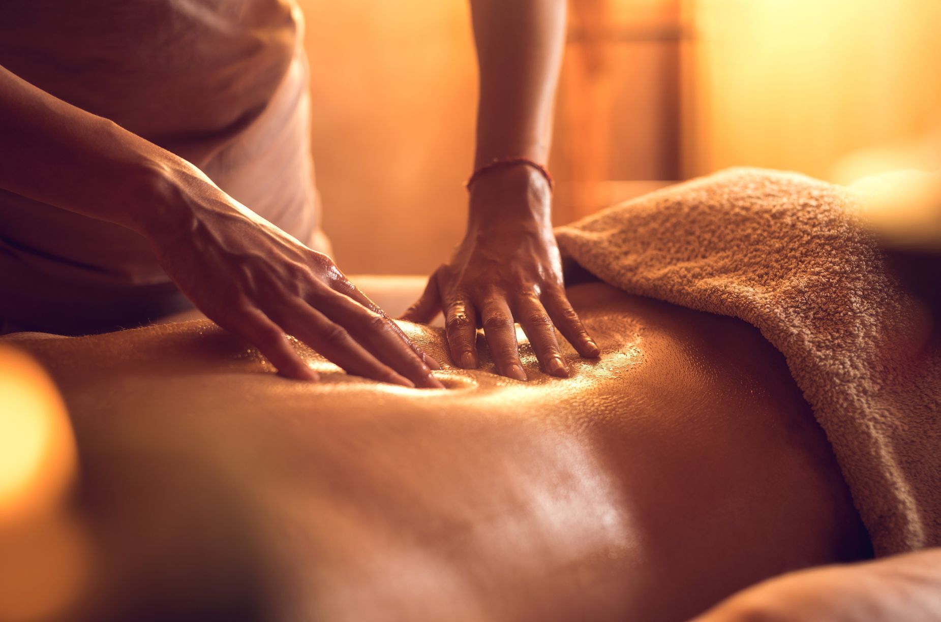 A massage therapy session with a person receiving a back massage.
