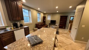 A spacious kitchen with granite countertops, wooden cabinets, and a large island. - North Hill Section Home; walk to UVMMC & UVM, Chabad, downtown, lake. (Burlington)