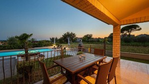 A covered outdoor area with a pool, wicker furniture, and a view of the landscape. - Stunning home in Kastelir-Labinci (Kastelir-Labinci)