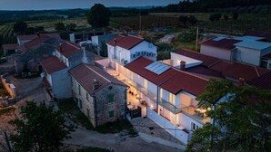 A residential area with houses featuring red-tiled roofs and a mix of modern and traditional architecture.