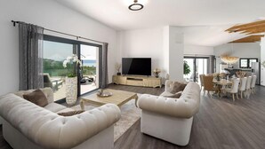 A spacious living room with a large TV, comfortable seating, and a dining area with a view. - Amazing home in Martina with sauna (Martina)