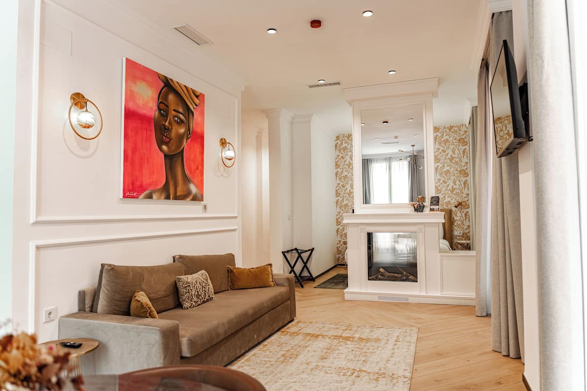 A modern living room with a sofa, a fireplace, and a television.