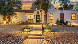 A house with a front porch, a door, and windows. - Historic Lux Retreat | Pool, Spa + 6 En-Suite Beds (Tucson)