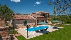 A two-story house with a swimming pool, outdoor seating, and a garden. - Beautiful home in Vodnjan (Vodnjan)