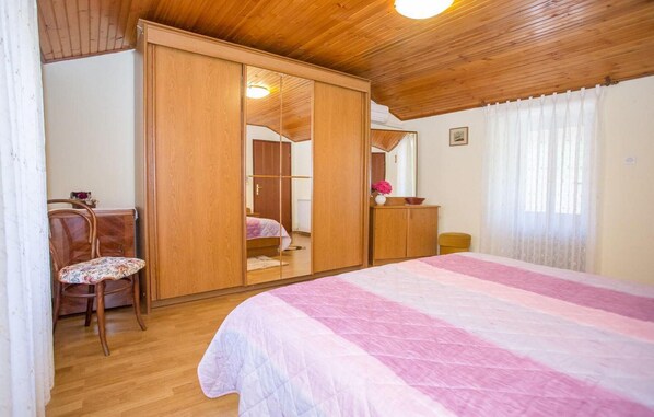 A bedroom with a bed, a chair, a wardrobe, and a mirror. - 2 bedroom cozy home in Tar-Vabriga (Tar-Vabriga)