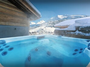 A hot tub with a view of snow-covered mountains. - Chalet Fernand - La Clusaz stylish stay for 10 with spa - OVO Network (La Clusaz)