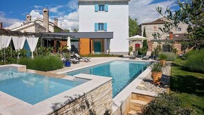 A modern two-story house with a swimming pool, outdoor seating, and a garden. - Gorgeous home in Porec (Porec)