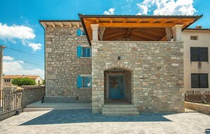 Traditional architecture meets modern charm in this two-story building with a welcoming entrance and a cozy balcony.