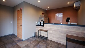 A modern kitchen with a wooden countertop, a coffee machine, and a small table. - HOTEL R9 The Yard Nagahama (Nagahama)