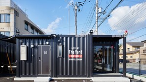 A compact hotel structure with a front desk, labeled "The Yard" and part of the R9 Hotels Group. - HOTEL R9 The Yard Nagahama (Nagahama)