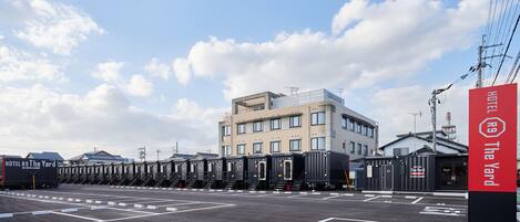 Un hotel con un edificio moderno y un estacionamiento.