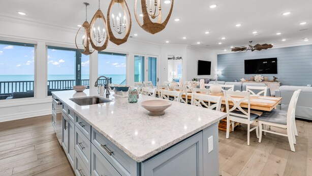 A spacious kitchen with a large island, modern pendant lights, and a view of the ocean. - Jonesin' By The Beach - Ocean Front & Channel Front in Garden City Beach (Garden City Beach)