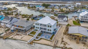 A coastal residential area with houses, docks, and boats. - Jonesin' By The Beach - Ocean Front & Channel Front in Garden City Beach (Garden City Beach)