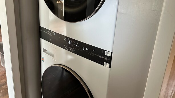 A front view of a wall-mounted washer and dryer unit. - Out in Left Field Home in Country Farm setting  (Laurens)