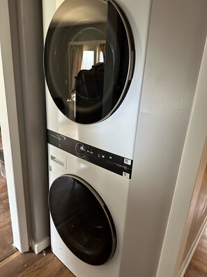 A front view of a wall-mounted washer and dryer unit. - Out in Left Field Home in Country Farm setting  (Laurens)