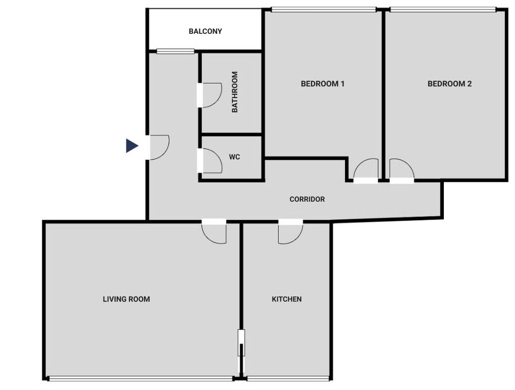 A floor plan with a living room, kitchen, two bedrooms, a balcony, a bathroom, and a WC.