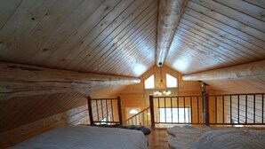A high-ceilinged wooden room with a loft area, a bed, and a staircase. - View! View! View! Relax in Nature!  (Fairbanks)