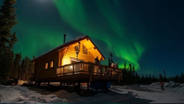 A wooden cabin with a deck, surrounded by snow and trees, under a night sky with the aurora borealis. - View! View! View! Relax in Nature!  (Fairbanks)
