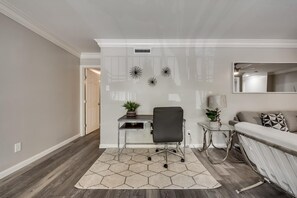 A modern office space with a desk, chair, and sofa. - GP54C - Upgraded 2BD Unit | Patio G. Prairie (Grand Prairie)
