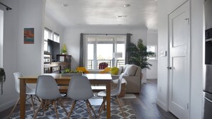 A modern kitchen with a dining area, a large window, and a view of the outdoors. - NEW Colorful + Spacious 3BD/2BA Home in the ❤️of Mill Valley
- Fully remodeled  (Mill Valley)