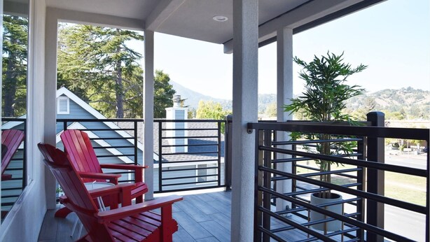 A covered balcony with red Adirondack chairs, a view of a mountain, and a parking lot. - NEW Colorful + Spacious 3BD/2BA Home in the ❤️of Mill Valley
- Fully remodeled  (Mill Valley)