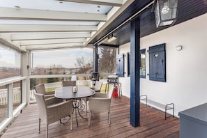 An outdoor patio with a table and chairs, a grill, and a view of the landscape. - Holiday Apartment "Homertstuebchen" with Private Terrace & Private Garden (Eslohe)