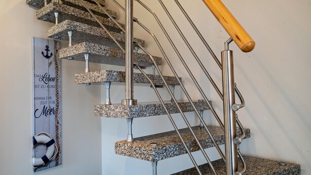 A staircase with granite steps and metal railings. - Holiday Home 'Ferienhaus Beckerwitz' with Private Terrace, Garden & Wi-Fi (Beckerwitz)
