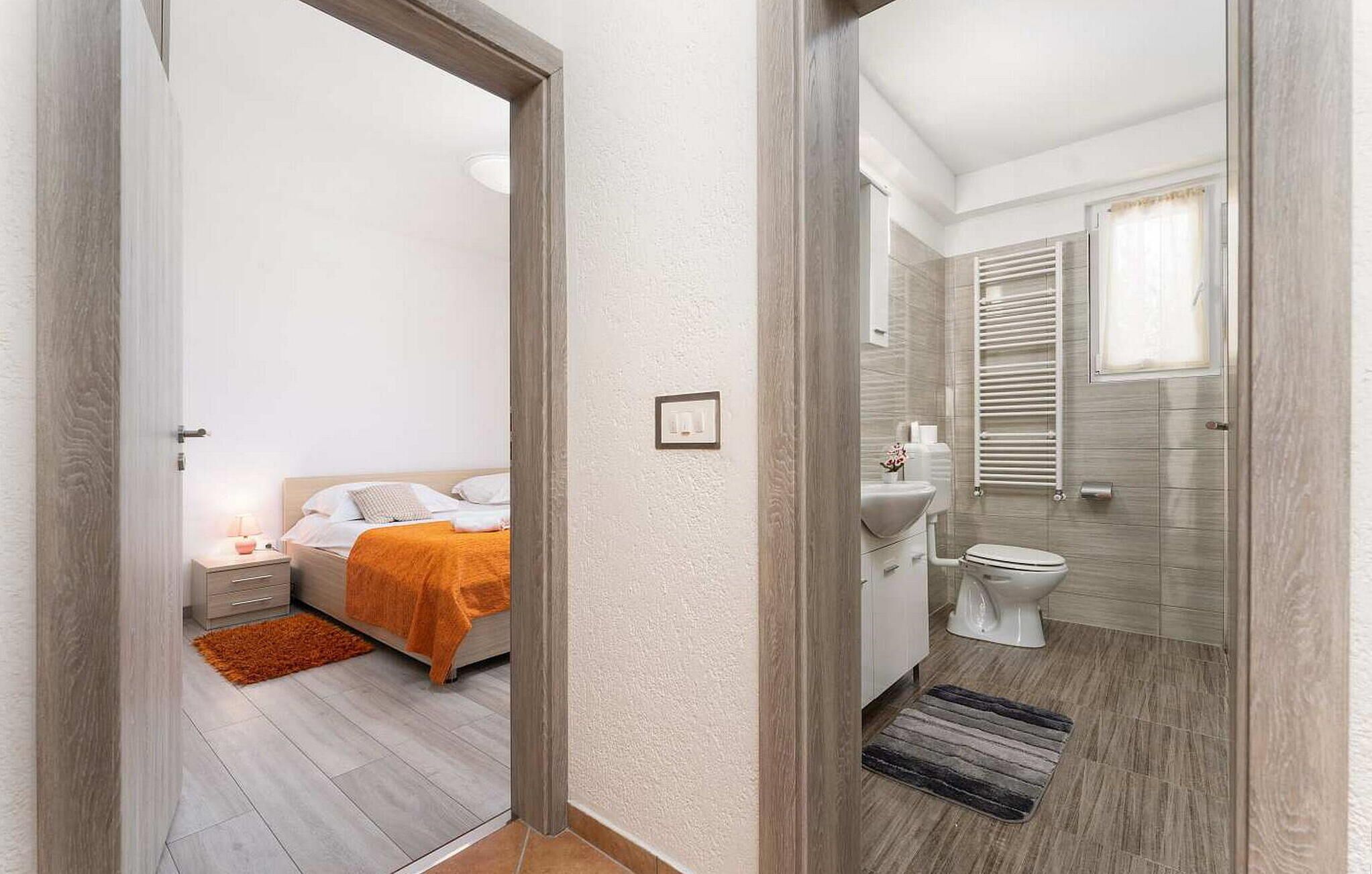 A modern bathroom with a toilet, sink, and towel rack.