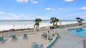 A pool area with lounge chairs and a view of the beach. - Watercrest 203 - FREE Beach Chairs! (Panama City Beach)