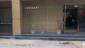 The exterior of Hotel Sangam Pacific with a tiled entrance and potted plants.