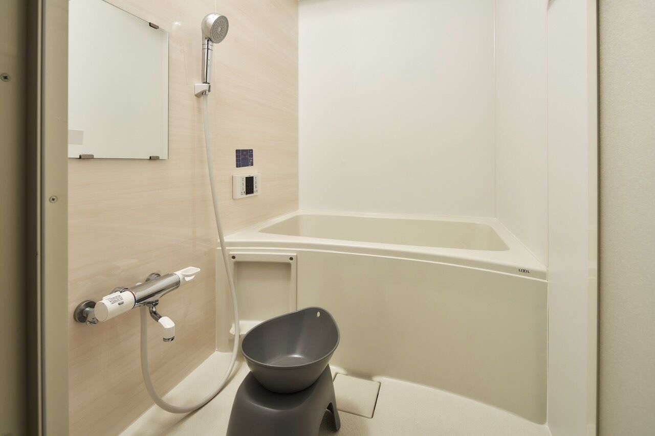 A bathroom with a bathtub, a shower, and a toilet.