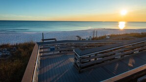 A wooden deck with benches overlooking a beach at sunset. - Beatles Retreat, 5 min WALK to Beach + Golf Cart & Arcade Machine, Dog Friendly! (Miramar Beach)